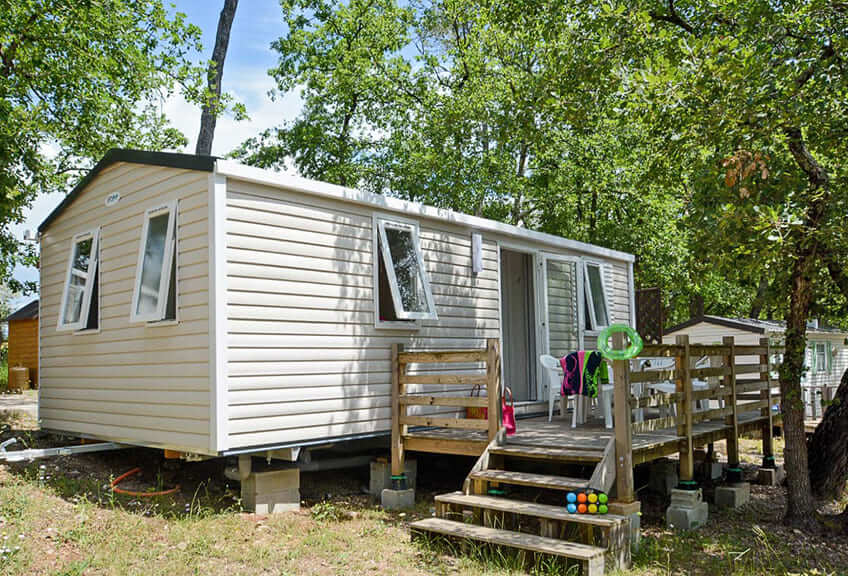 Vue extérieure du mobil-home Confort 4 personnes et sa terrasse extérieure, en location vacances dans le Var